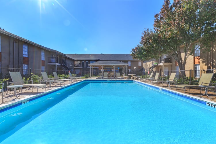 Swimming pool surrounded by pool chairs at The Vibe at Clear Lake in Webster, Texas