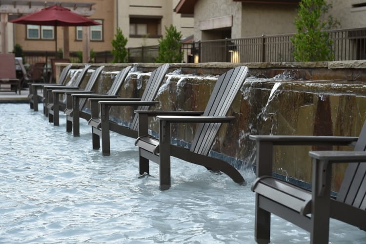 A row of chairs, poolside at Overlook Ranch in Fort Worth, Texas