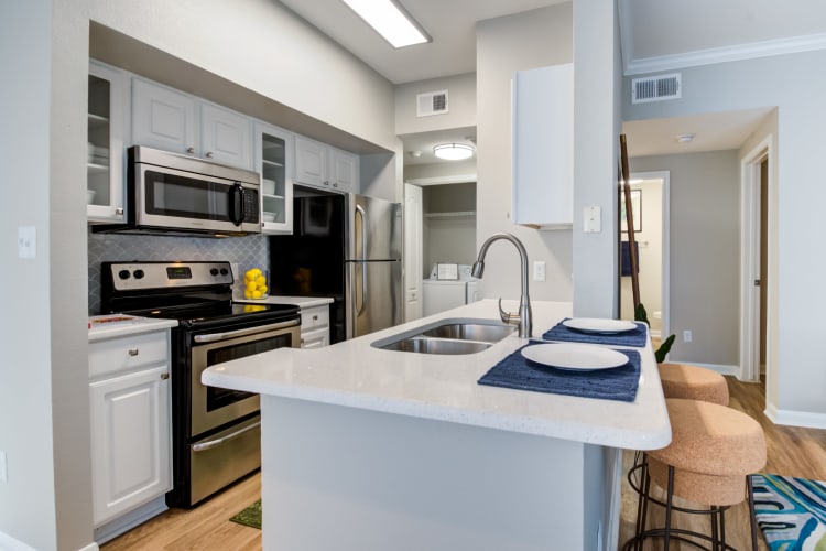 Open-concept layout with hardwood floors and accent walls in a model home at Baypoint in Corpus Christi, Texas