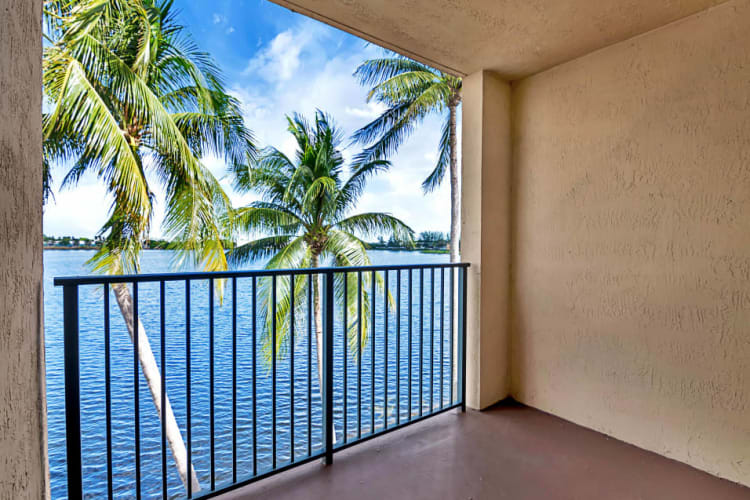 Private balcony with stunning lake views at St. Tropez Apartments in Miami Lakes, Florida