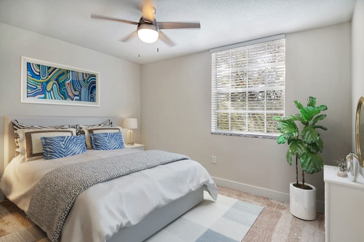 Model bedroom with ceiling fan at St. Tropez Apartments in Miami Lakes, Florida