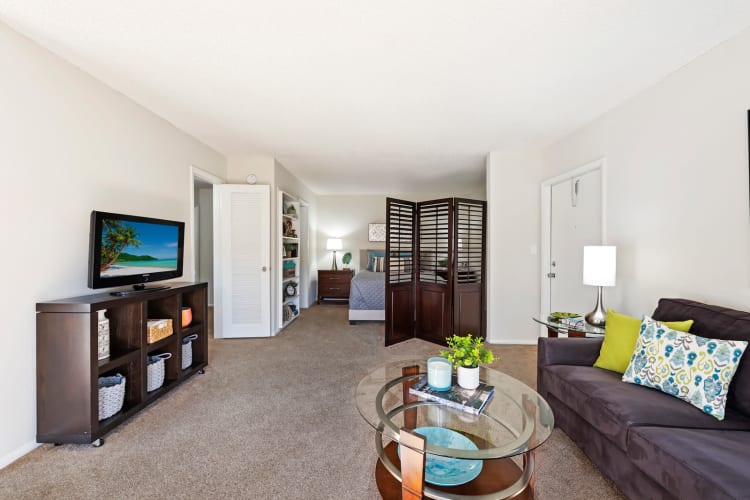 Living room area and bedroom nook at Executive Apartments in Miami Lakes, Florida