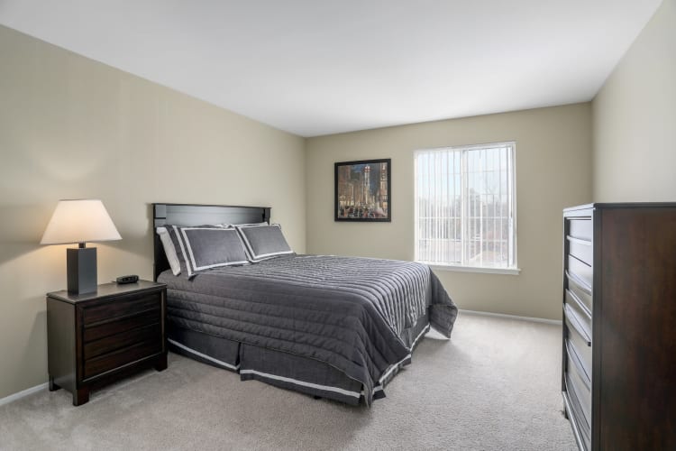 Model bedroom with gray accents at Town Court in West Bloomfield, Michigan