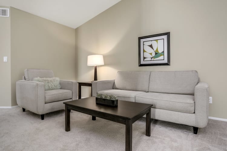 Model living space with wall art at Town Court in West Bloomfield, Michigan