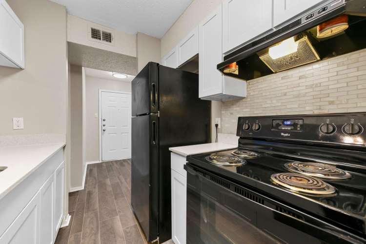 Kitchen with a refrigerator at Misty Hollow in Arlington. TX 
