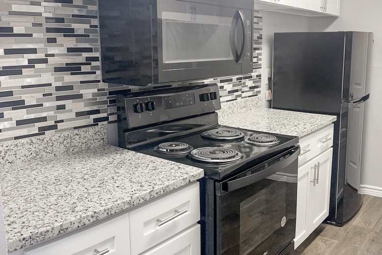 Spacious island kitchen with granite countertops at Oaks of Wimbledon in Spring, Texas, 