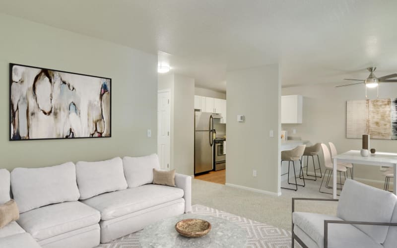 Spacious living room connected to the dining room and kitchen in an apartment at Carriage House Apartments in Vancouver, Washington