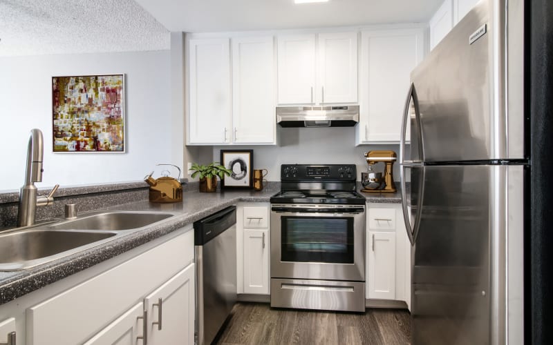 Enjoy a fully renovated kitchen with white cabinets at Lakeview Village Apartments in Spring Valley, California