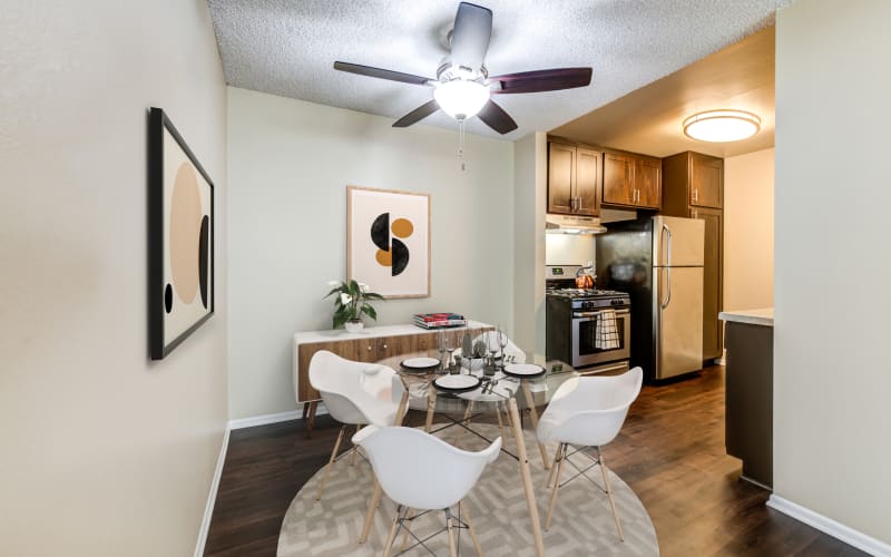 Spacious dining room and kitchen with hardwood-style floors at Kendallwood Apartments in Whittier, California