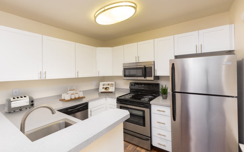 Kitchen with White Renovate Cabinetry at Autumn Chase Apartments in Vancouver,