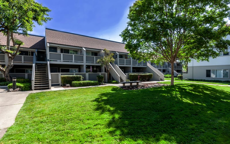 Exterior view of the property and landscaping at The Timbers Apartments in Hayward, California