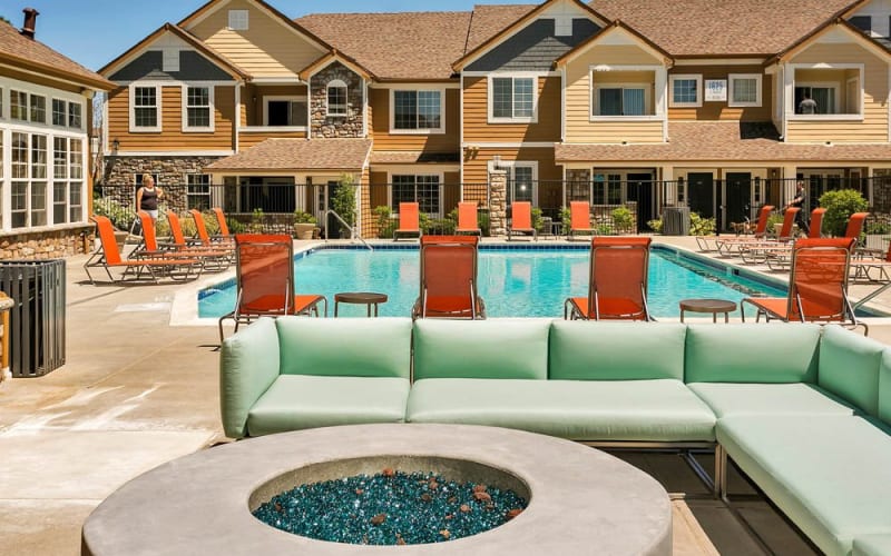 Fire pit lounge area poolside at Crestone Apartments in Aurora, Colorado
