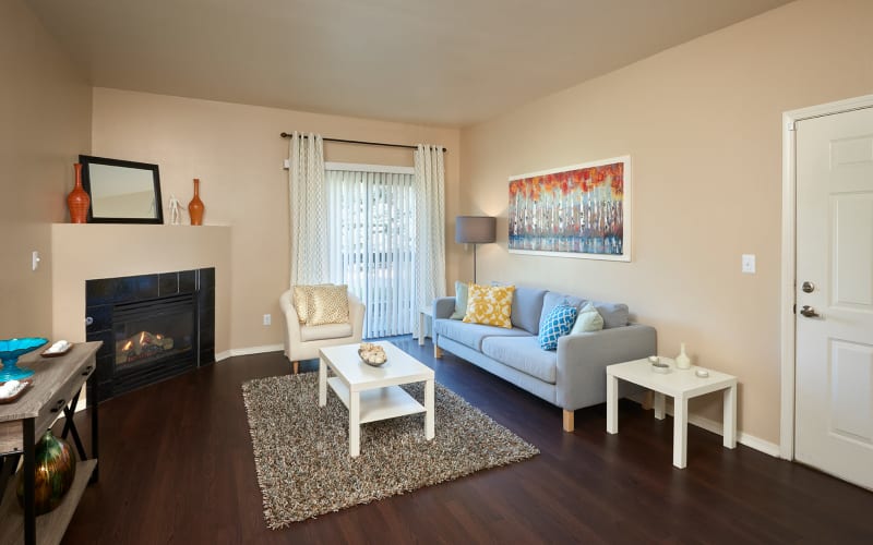 Living room with a gas fireplace at Crossroads at City Center Apartments in Aurora, Colorado