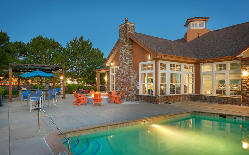 Fire pit lounge area poolside and pool at sunrise at Crestone Apartments in Aurora, Colorado