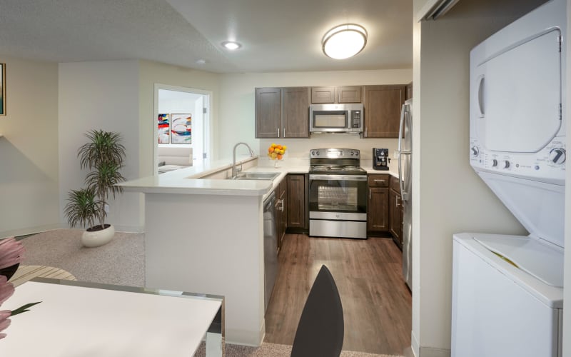 Kitchen looking over the living room in an open floor plan at Bluesky Landing Apartments in Lakewood, Colorado