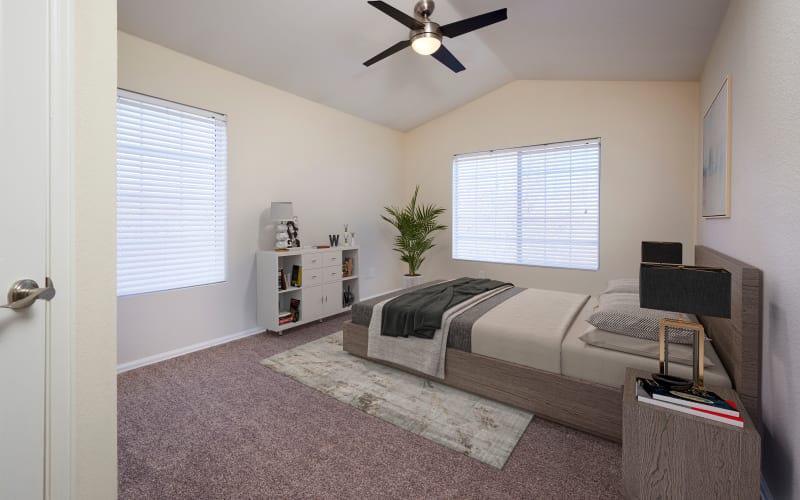 Spacious master bedroom with plush carpeting at The Crossings at Bear Creek Apartments in Lakewood, Colorado