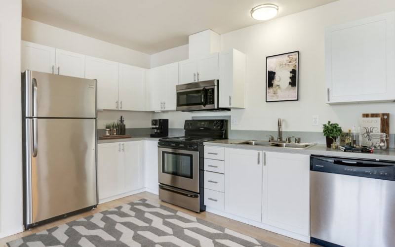 Renovated kitchen with white cabinets at The Addison Apartments in Vancouver, Washington