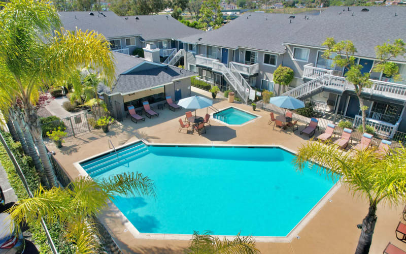 The sparkling swimming pool and hot tub on a sunny day at Hillside Terrace Apartments in Lemon Grove, California
