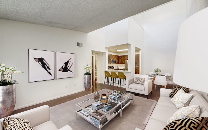 Spacious living room with view of dining room and kitchen at Tuscany Village Apartments in Ontario, California