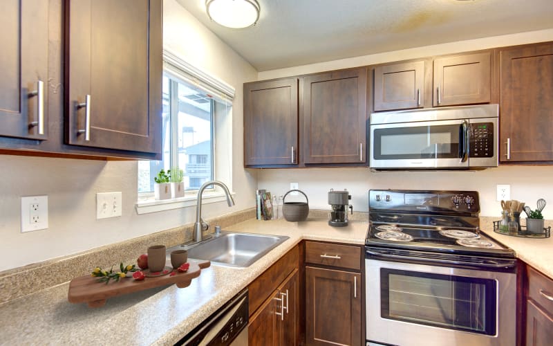 Spacious kitchen with espresso cabinets at Latitude Apartments in Everett, Washington