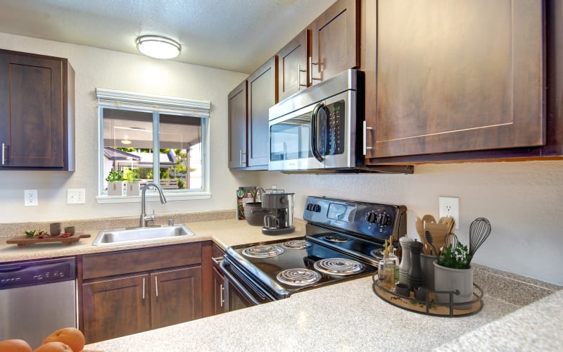 Renovated kitchen with espresso cabinets at Latitude Apartments in Everett, Washington