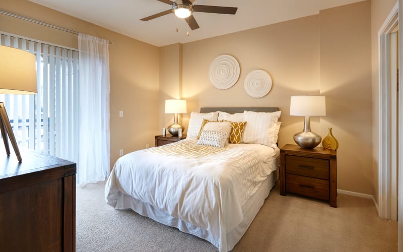 Spacious master bedroom with plush carpeting at Legend Oaks Apartments in Aurora, Colorado