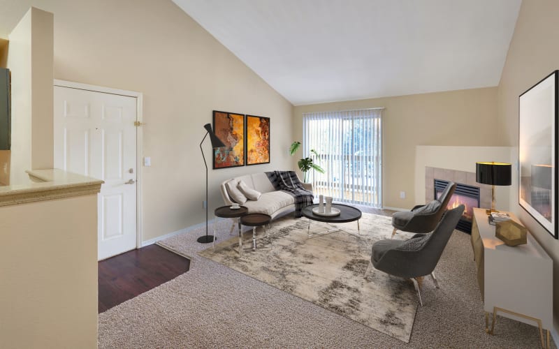 Living room with a gas fireplace at Crossroads at City Center Apartments in Aurora, Colorado
