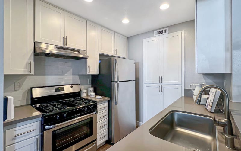 Kitchen with stainless steel appliances at Portofino Townhomes in Wilmington, California