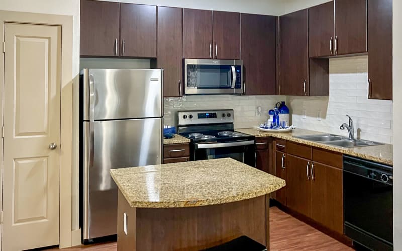 Spacious kitchen with hardwood-style floors at Broadstone Grand Avenue in Pflugerville, Texas
