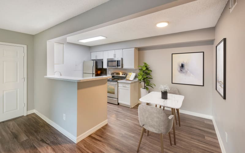 Renovated kitchen with white cabinets at Alton Green Apartments in Denver, Colorado