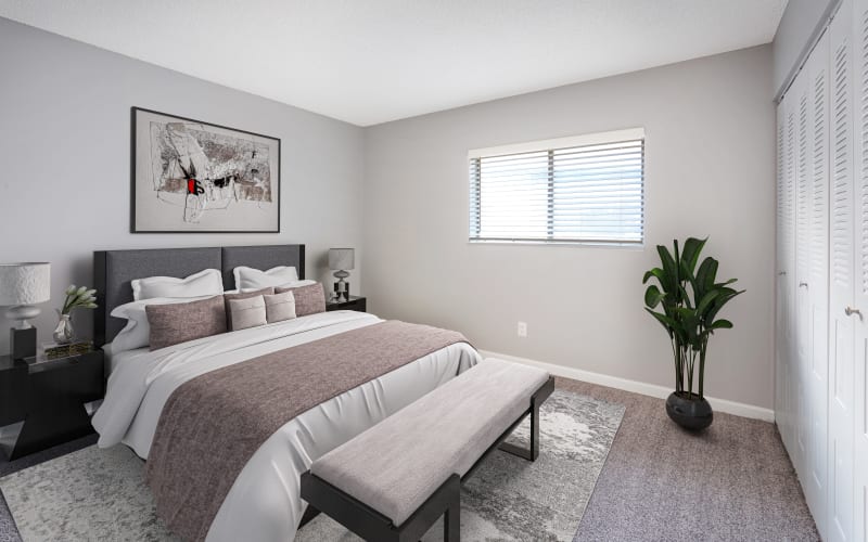 Spacious master bedroom with plush carpeting at Alton Green Apartments in Denver, Colorado