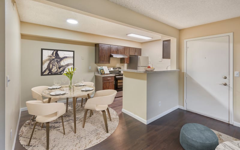 Living and Dining Room with Renovated Brown Cabinets at Alton Green Apartments in Denver, Colorado