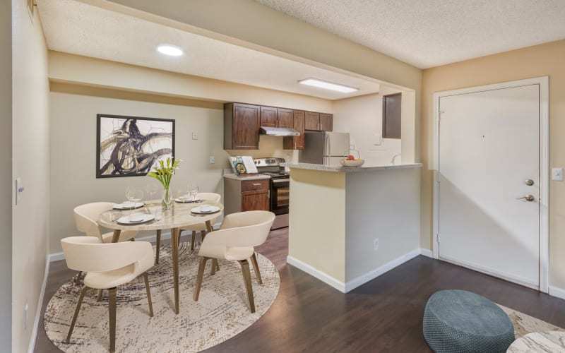 Espresso cabinets in the kitchen overlooking the dining room at Alton Green Apartments in Denver, Colorado