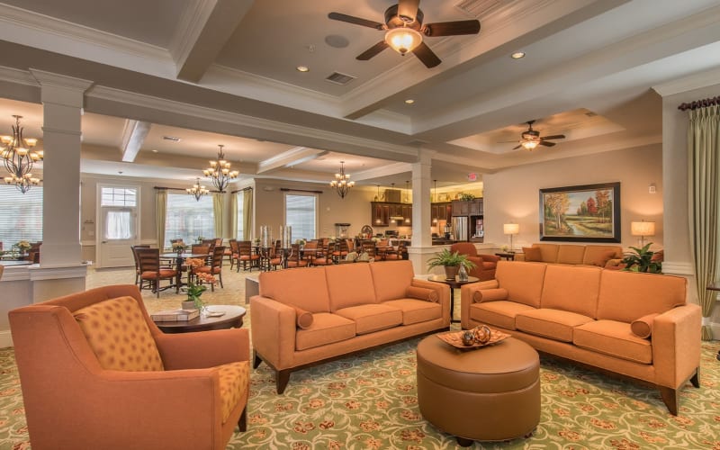 Lounge area with orange couches at Barclay House of Aiken in Aiken, South Carolina