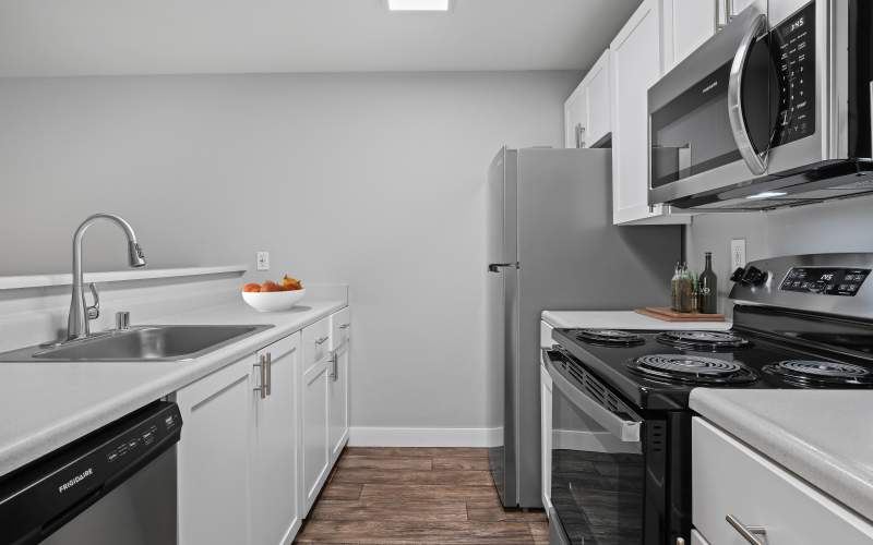 Renovated kitchen with white cabinets at Renaissance at 29th Apartments in Vancouver, Washington