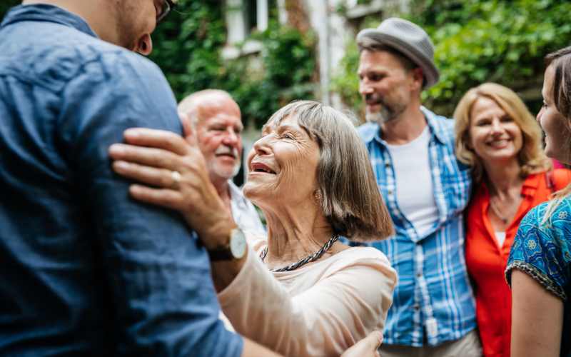 Resident dancing with her son at The Pineapple House at Sapphire Lakes in Naples, Florida