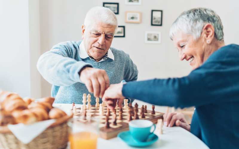 Residents playing chess at The Pineapple House at Sapphire Lakes in Naples, Florida