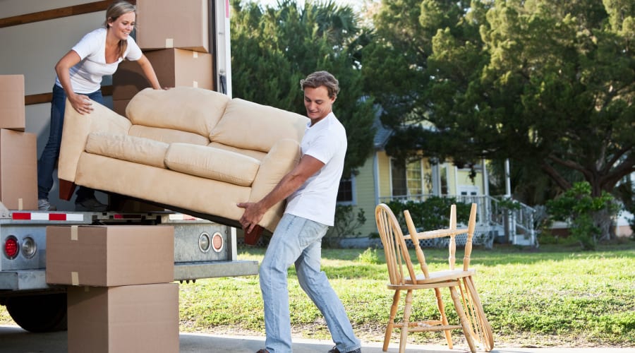A couple moving furniture from a truck at Wheeler Road Self Storage in Augusta, Georgia