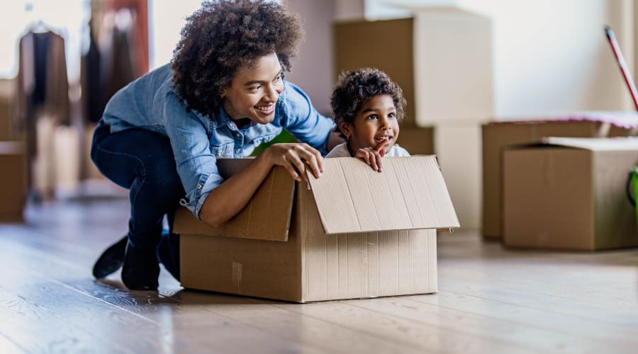 An adult playing with a child in a storage box near KO Storage of Juneau in Juneau, Wisconsin