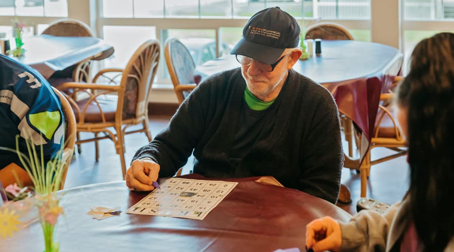 Resident playing bingo at 6th Ave Senior Living in Tacoma, Washington