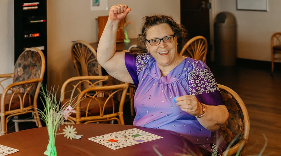 Happy resident winning bingo at 6th Ave Senior Living in Tacoma, Washington