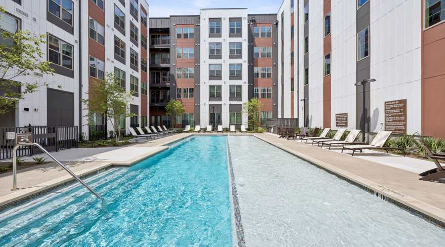 Pool with lounge chairs at The Margaret at Riverfront in Dallas, Texas