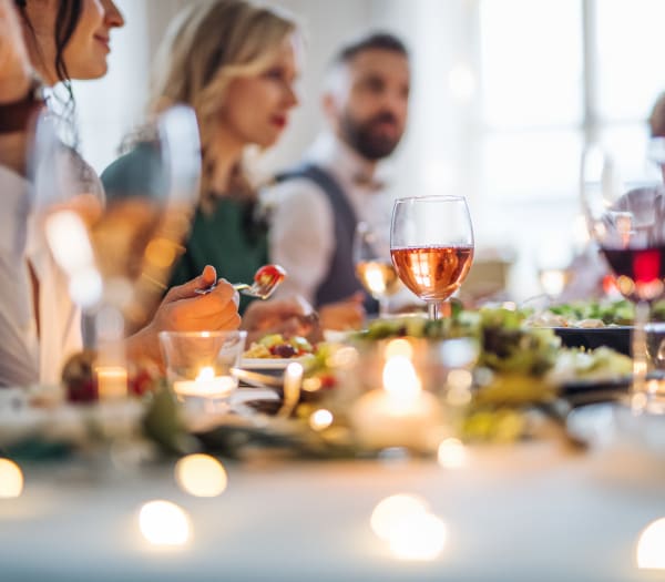 Residents enjoying company over drinks and a meal in their new apartment at The Columbia at the Waterfront in Vancouver, Washington