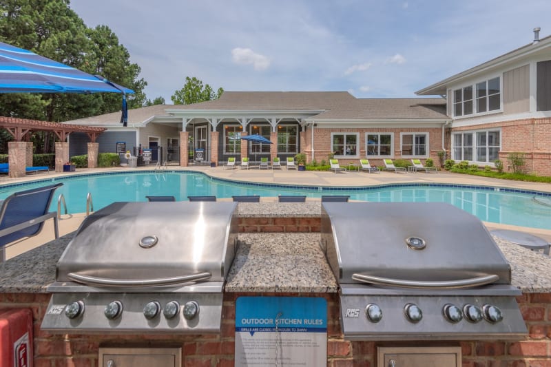 Barbecue area with gas grills overlooking the swimming pool at 200 East in Durham, North Carolina