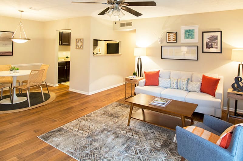 Well-furnished living area with a ceiling fan in an open-concept model home at The Everette at East Cobb in Marietta, Georgia