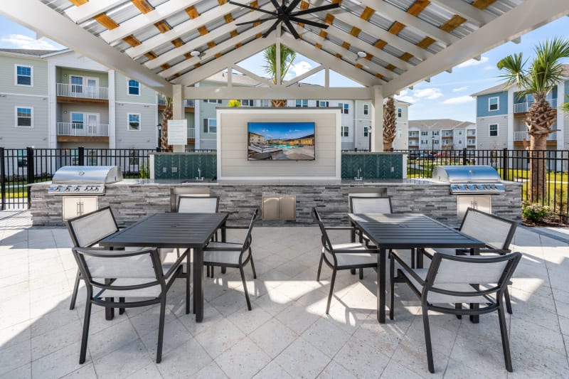 Outdoor BBQ area and gazebo by the pool at Argyle at Oakleaf Town Center in Jacksonville, Florida