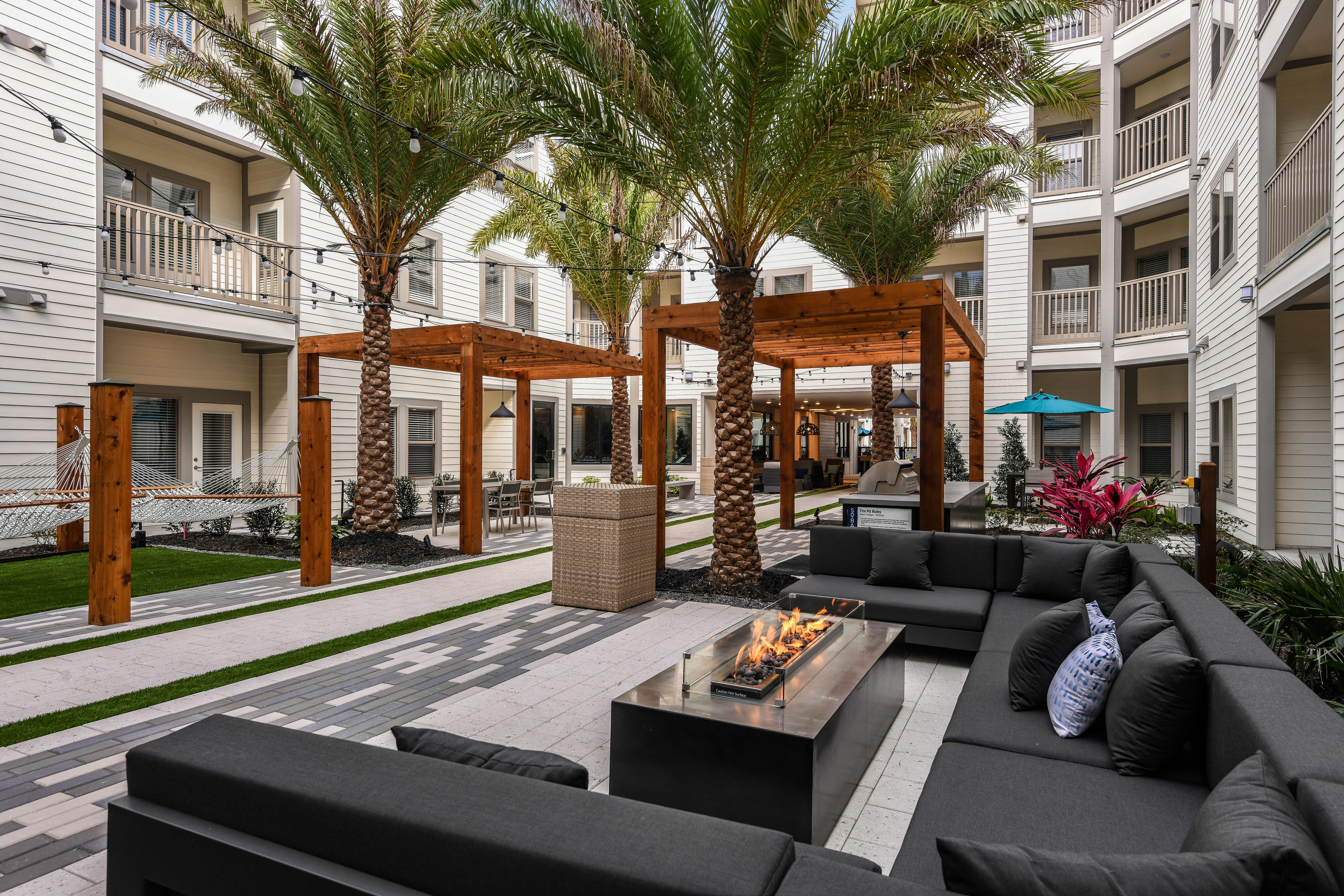 Outdoor patio with firepit Amenities at SoBA Apartments in Jacksonville, Florida