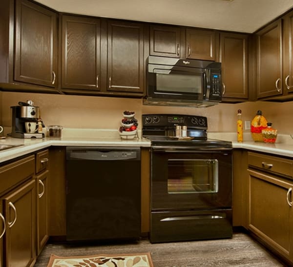 Kitchen with glass-top stove at Sonoran Apartment Homes