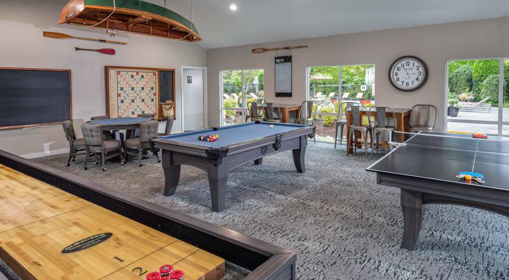 Game room with multiple games at Campbell Run Apartments in Woodinville, Washington