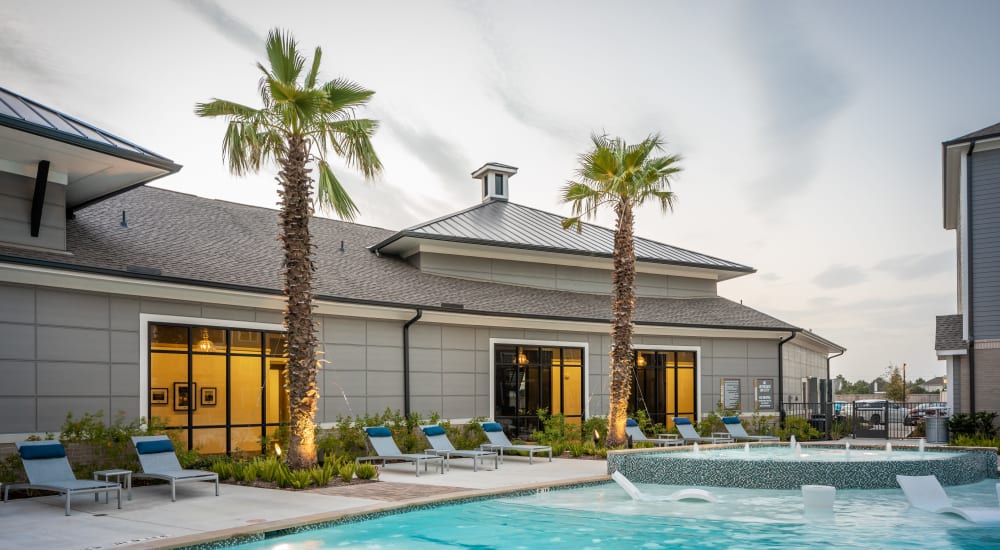 Large inground pool with palm trees at Bellrock Market Station in Katy, Texas